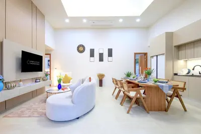 a living room with a couch and a table at Phirunda Pool Villas in Ban Suan