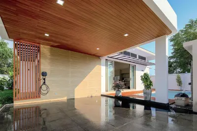 an external view of a house with a wooden ceiling at Phirunda Pool Villas in Ban Suan