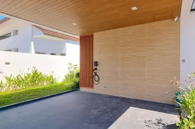 an external view of a house with a pivot door at Phirunda Pool Villas in Ban Suan