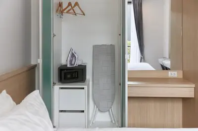 a bedroom with a bed and a desk with a heater at Comfy 1-BR Grand Kata VIP condo, 5 min to Kata beach in Kata Beach
