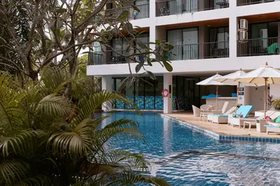 a swimming pool in front of a hotel at Comfy 1-BR Grand Kata VIP condo, 5 min to Kata beach in Kata Beach