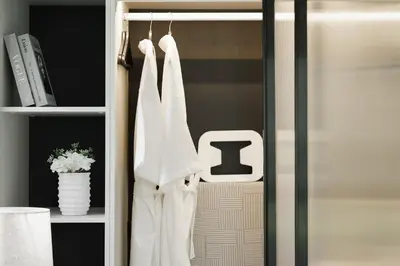a closet with white towels hanging on a rack at The Title Legendary Grand Pool Access in Bang Tao Beach
