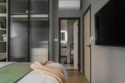 a bedroom with a bed and a flat screen tv at The Title Legendary Grand Pool Access in Bang Tao Beach