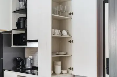 a kitchen with white walls and a white pantry at The Title Legendary Grand Pool Access in Bang Tao Beach