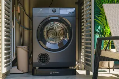 a washing machine sitting next to a chair at The Title Legendary Grand Pool Access in Bang Tao Beach