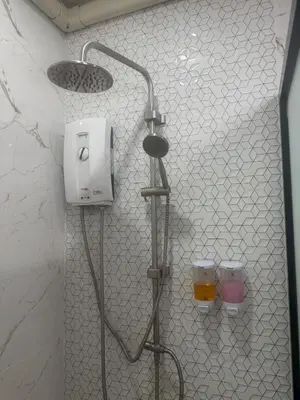 a shower in a bathroom with two glasses of beer at Sunisa Resort in Phuket Town
