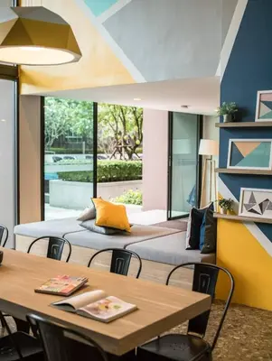 two beds in a room with a table and chairs at Valley Mountain View&City Proximity Golden Eight Apartment in Ban Phlu Yai