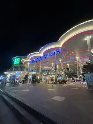 a large building with a neon sign at night at Grand Patong Apartment 7FL in Patong Beach