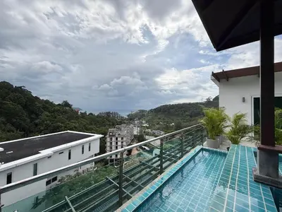 a balcony with a swimming pool on top of a building at Kamala Seaview - 3 BR Private Pool Villa in Kamala Beach