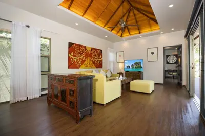 a living room with a yellow couch and a table at Private 3BR Pool Villa Mylico 3min drive Nai Harn Beach in Rawai Beach
