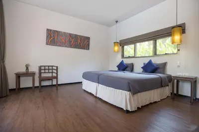 a bedroom with a bed with blue pillows and a window at Private 3BR Pool Villa Mylico 3min drive Nai Harn Beach in Rawai Beach