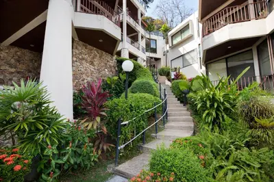 a stairway in a apartment building with plants at 3 BR Seaview Apt with pool access ADMC 100-2 in Ban Ao Makham