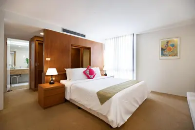 a bedroom with a large bed with a pink pillow at 3 BR Seaview Apt with pool access ADMC 100-2 in Ban Ao Makham