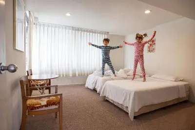 two children jumping on beds in a bedroom at 3 BR Seaview Apt with pool access ADMC 100-2 in Ban Ao Makham