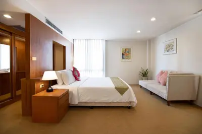 a bedroom with a bed and a couch at 3 BR Seaview Apt with pool access ADMC 100-2 in Ban Ao Makham