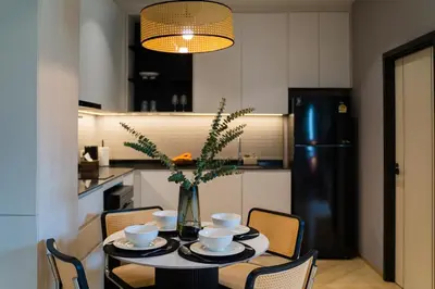 a kitchen with a table with a vase of flowers at Family Title Legendary 2Bdr Bang Tao in Bang Tao Beach