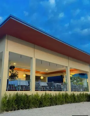 a building with tables and chairs in it at La La Lay Beach House in Tab Kaek Beach