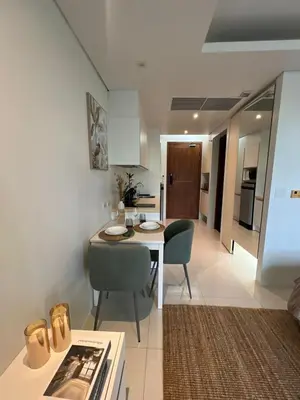 a kitchen and living room with a table and chairs at Spacious beautiful studio with big patio on the pool side ! in Rawai Beach