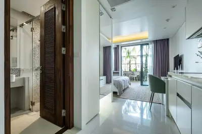 a room with a kitchen and a living room at Spacious beautiful studio with big patio on the pool side ! in Rawai Beach