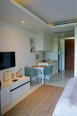 a kitchen and living room with a bed and a table at Spacious beautiful studio with big patio on the pool side ! in Rawai Beach