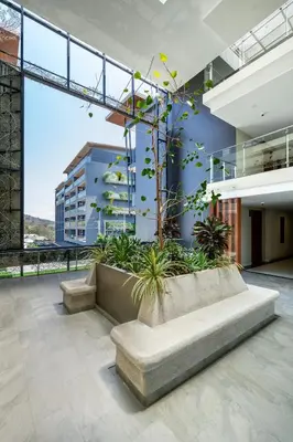 a lobby of a building with a couch and plants at Spacious beautiful studio with big patio on the pool side ! in Rawai Beach