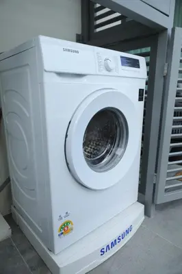a washing machine sitting on top of a washer at Cozy 1 Bdr Title Legendary Bang Tao 5 min to the Beach in Bang Tao Beach