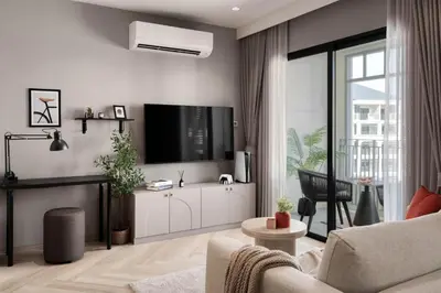 a living room with a tv on a wall at Cozy 1 Bdr Title Legendary Bang Tao 5 min to the Beach in Bang Tao Beach