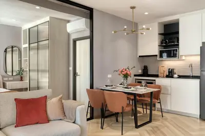 a kitchen and dining room with a table and chairs at Cozy 1 Bdr Title Legendary Bang Tao 5 min to the Beach in Bang Tao Beach