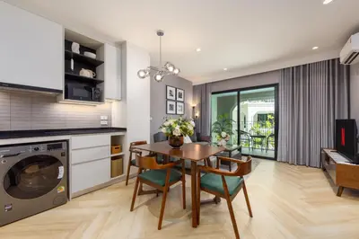 a kitchen and dining room with a table and chairs at Oliva 1BR Suite — The Title Legendary BangTao in Bang Tao Beach