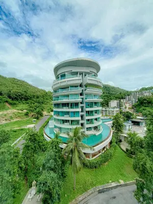 a large building with a pool in front of it at The Ark Karon Beach by RESAVA in Karon Beach