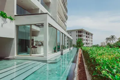 an external view of a building with a swimming pool at The Ark Karon Beach by RESAVA in Karon Beach