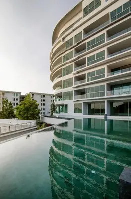 a swimming pool in front of a building at The Ark Karon Beach by RESAVA in Karon Beach