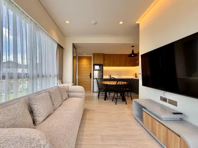 a living room with a couch and a large flat screen tv at Laguna Lakeside by Villacarte in Bang Tao Beach