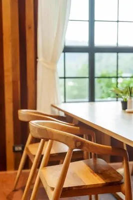 a wooden table with two chairs and a window at Harley 1 BDR Condo Kata Hill, 3 Mins To kata Beach in Kata Beach