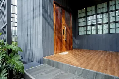 a wooden door in a building with windows at Harley 1 BDR Condo Kata Hill, 3 Mins To kata Beach in Kata Beach