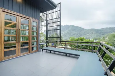 a bench on the balcony of a building at Harley 1 BDR Condo Kata Hill, 3 Mins To kata Beach in Kata Beach