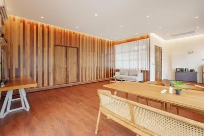 a living room with wooden walls and a table at Harley 1 BDR Condo Kata Hill, 3 Mins To kata Beach in Kata Beach