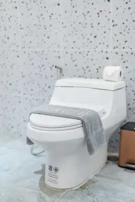 a white toilet with a towel on it in a bathroom at Harley 1 BDR Condo Kata Hill, 3 Mins To kata Beach in Kata Beach