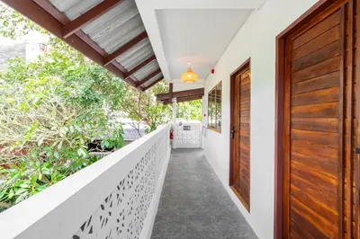 a corridor of a house with wooden doors at The Banyan House in Patong Beach