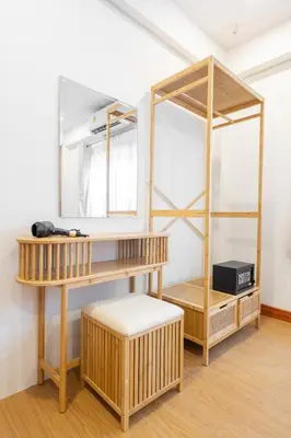 a dressing room with wooden shelves and a mirror at The Banyan House in Patong Beach
