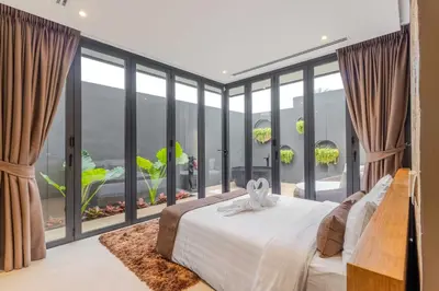 a bedroom with a bed and large glass windows at V263 Brand New 3BR Super Modern Pool Villa - Calathea in Thalang
