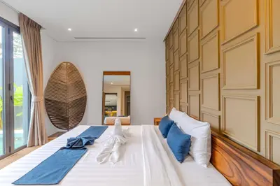 a bedroom with a large bed with two towels on it at V263 Brand New 3BR Super Modern Pool Villa - Calathea in Thalang