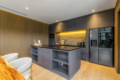 a kitchen with a counter and some chairs in it at V263 Brand New 3BR Super Modern Pool Villa - Calathea in Thalang