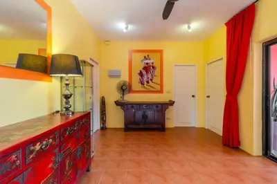 a living room with a red dresser and yellow walls at V265 2BR Pool Villa Near Fitness Gyms Muay Thai in Ban Saiyuan (1)