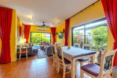 a dining room with a table and chairs at V265 2BR Pool Villa Near Fitness Gyms Muay Thai in Ban Saiyuan (1)