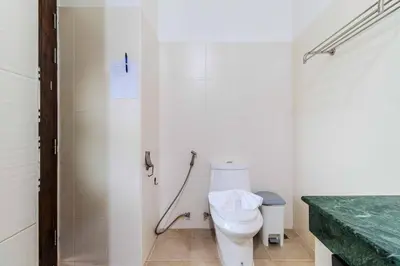 a bathroom with a white toilet and a shower at V267 Newly Renovated 2BR with Pool Near Beaches in Ban Saiyuan (1)