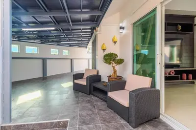 a living room with two chairs and a plant at V267 Newly Renovated 2BR with Pool Near Beaches in Ban Saiyuan (1)