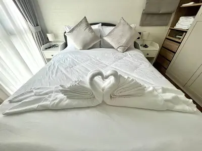 two swans making a heart shape on a bed at MO607 1 br 36m in Nai Yang Beach