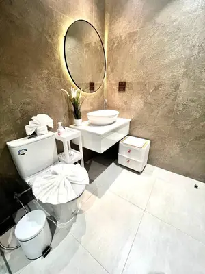 a bathroom with a toilet and a sink and a mirror at MO607 1 br 36m in Nai Yang Beach