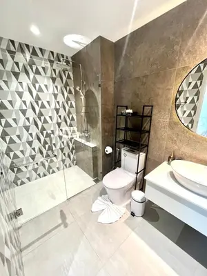 a bathroom with a toilet and a shower and a sink at MO607 1 br 36m in Nai Yang Beach